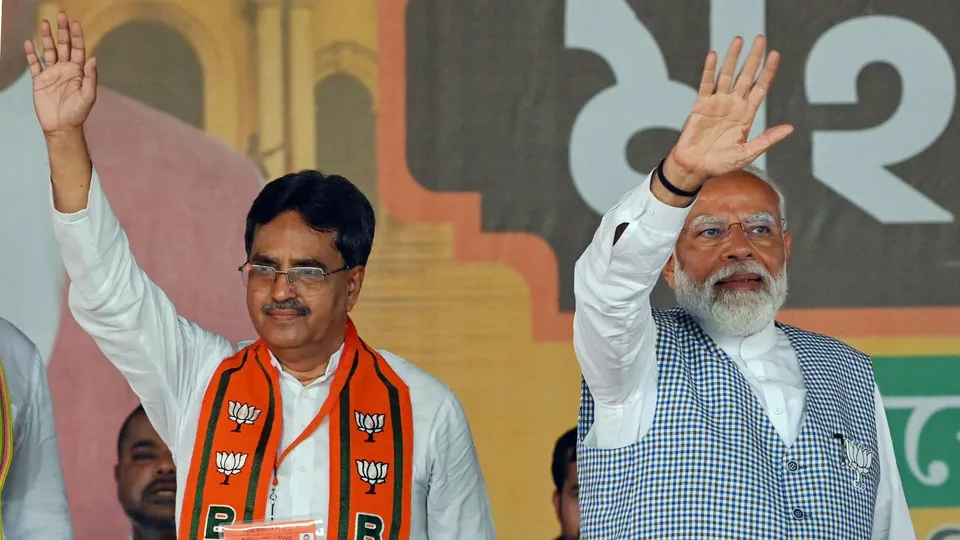 Prime Minister Narendra Modi and Tripura Chief Minister Manik Saha wave at supporters during a public rally ahead of Lok Sabha elections, in Agartala, Wednesday, April 17, 2024