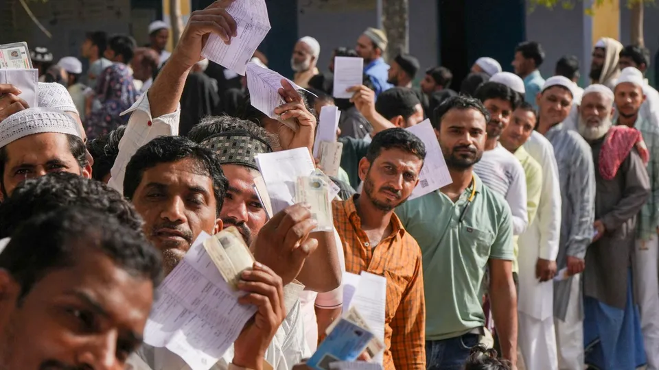 Voters show their ID cards after casting their votes during the first phase of Lok Sabha elections, in Kairana, Uttar Pradesh, Friday, April 19, 2024