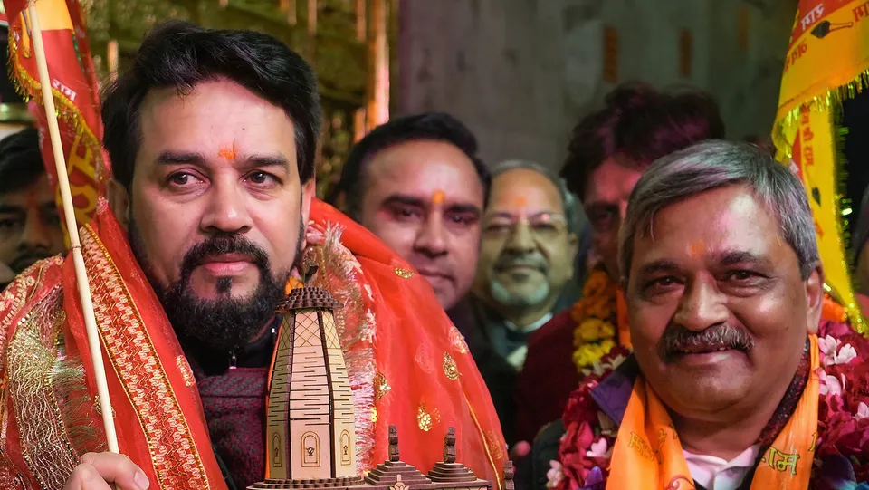 Union Minister Anurag Singh Thakur with NDMC Vice Chairman Satish Upadhyay holds a model of the Shri Ramjanmbhoomi Mandir