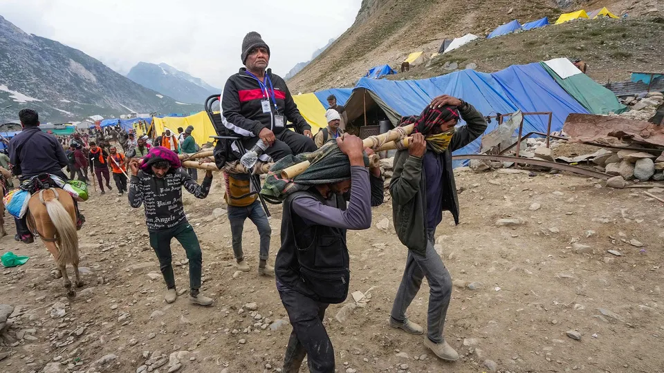 A pilgrim being carried on a palanquin at Sheshnag during Amarnath Yatra 2023
