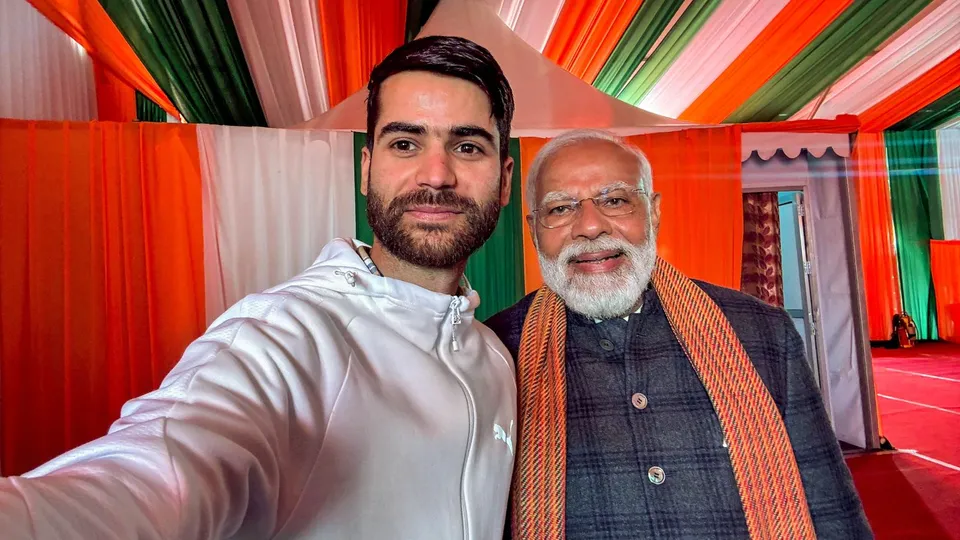 Prime Minister Narendra Modi with Nazim, a resident of J&K's Pulwama district, during the 'Viksit Bharat, Viksit Jammu & Kashmir' programme, in Srinagar