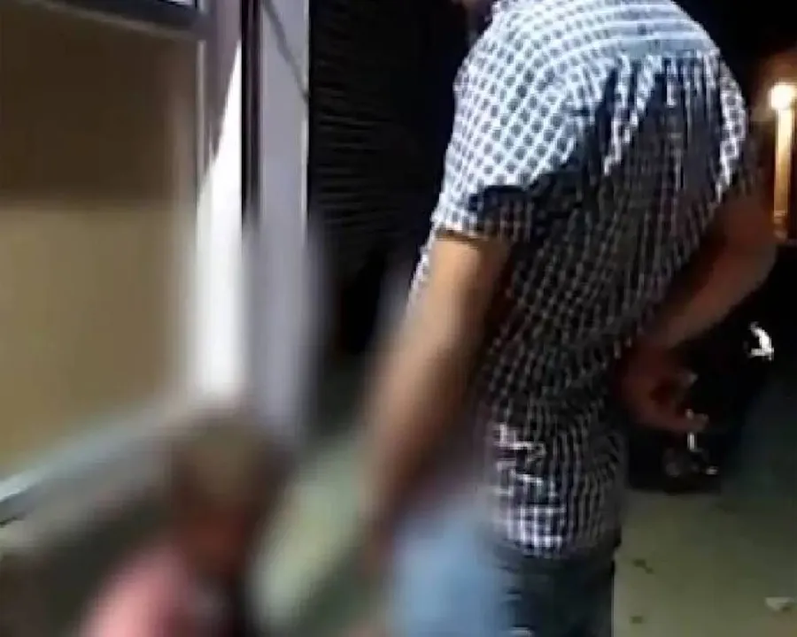 Man urinating on a tribal youth.jpg