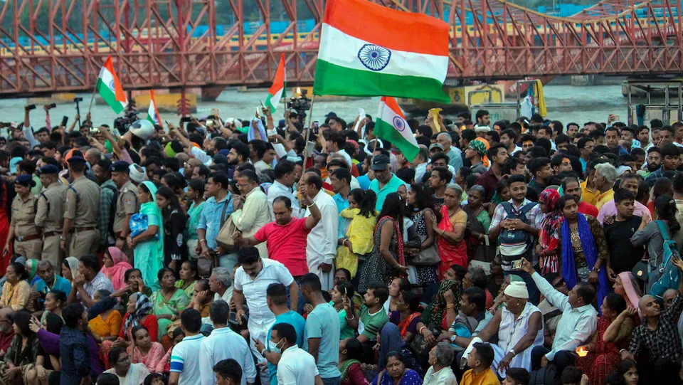 Supporters gather at Har Ki Pauri ghat where protesting wrestlers arrived to immerse their medals in the Ganga river as a mark of protest against WFI chief Brij Bhushan Singh over sexual harassment allegations, in Haridwar, on May 30, 2023. The wrestlers dropped their plan to immerse medals in the river after a request from farmer leaders.