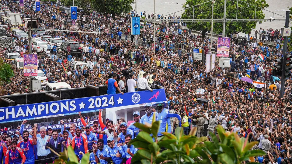 Crowd waits outside the Wankhede Stadium ahead of India's T20 World Cup-winning cricket team's arrival for a felicitation ceremony after an open bus victory parade, in Mumbai, Thursday, July 4, 2024.