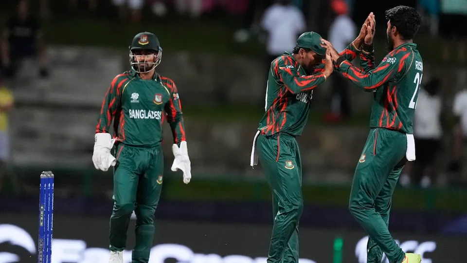 Bangladesh's Rishad Hossain, right, celebrates with teammates after taking the wicket of Australia's captain Mitchell Marsh during the ICC Men's T20 World Cup cricket match between Australia and Bangladesh in North Sound, Antigua and Barbuda, Thursday, June 20, 2024.