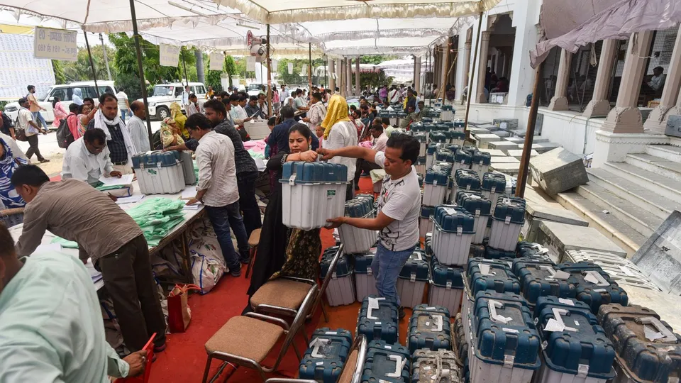 Polling officials receive the Electronic Voting Machines (EVM) and Voter Verifiable Audit Paper Trail (VVPAT) at KP Inter College on the eve of the sixth phase of Lok Sabha elections, in Prayagraj, Friday, May 24, 2024