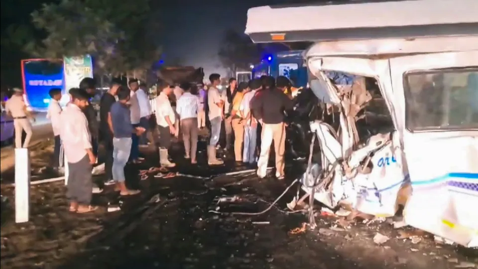People gather near mangled remains of a vehicle after an accident with a truck that killed at least seven people and injured 20, in Ambala district, early Friday, May 24, 2024