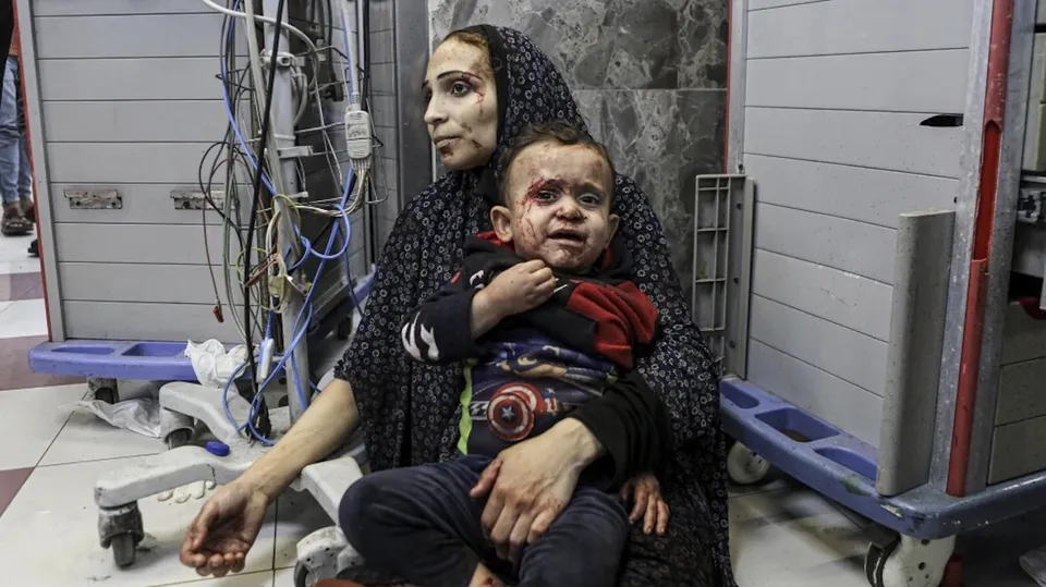 Wounded Palestinians wait for treatment in al-Shifa hospital in Gaza City