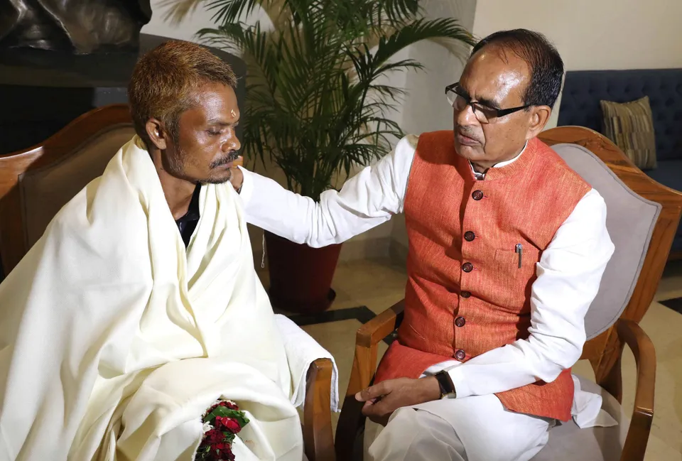 Madhya Pradesh Chief Minister Shivraj Singh Chouhan presents a shawl to Dashmat Rawat, Sidhi urination case victim, at CM House, in Bhopal