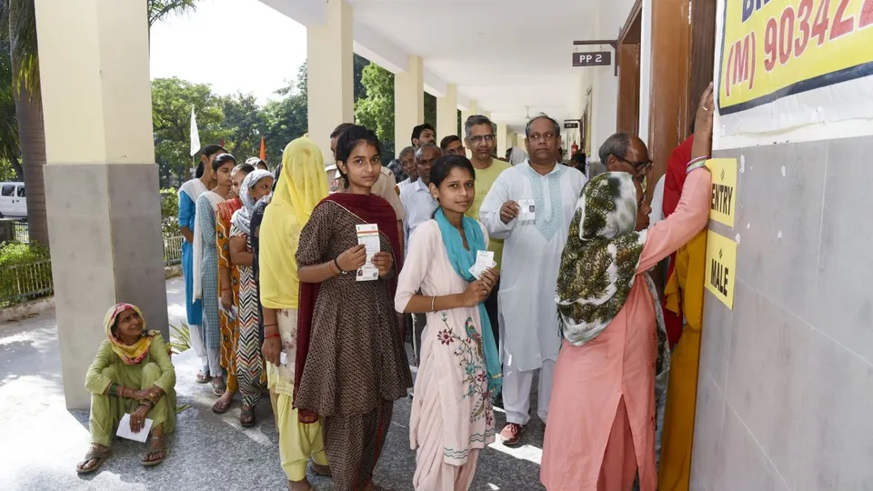 Voters wait to cast their votes during Haryana Assembly elections, in Sonipat, Saturday, Oct. 5, 2024