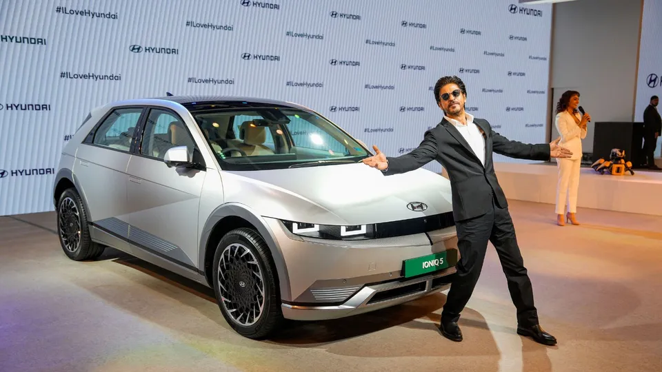 Bollywood actor Shah Rukh Khan poses next to Hyundai's all-electric SUV 'IONIQ 5' during its launch at the Auto Expo 2023, in Greater Noida, Wednesday, Jan. 11, 2023.