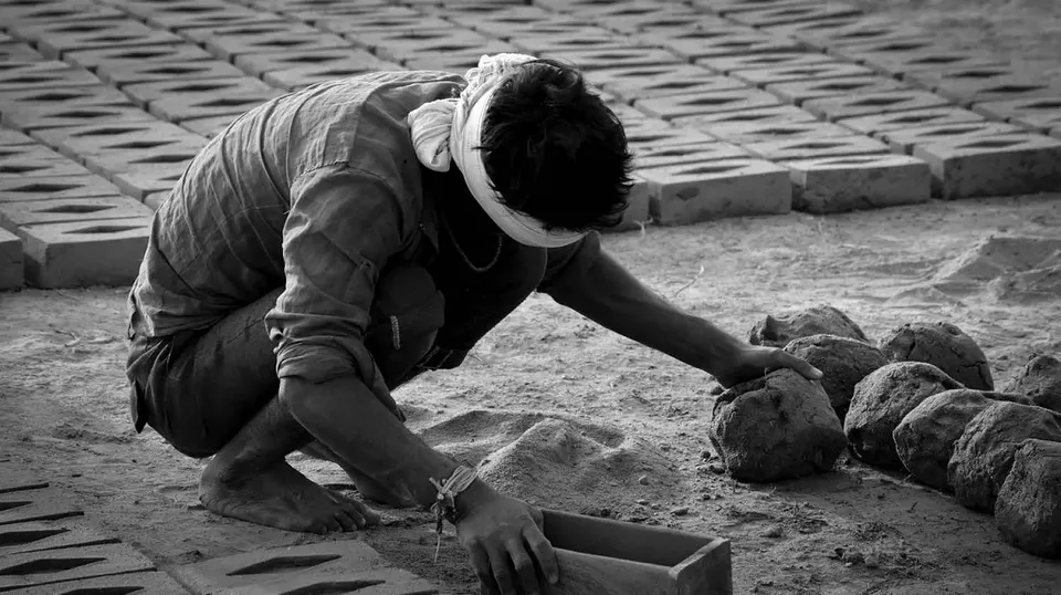 Bonded labour making clay bricks