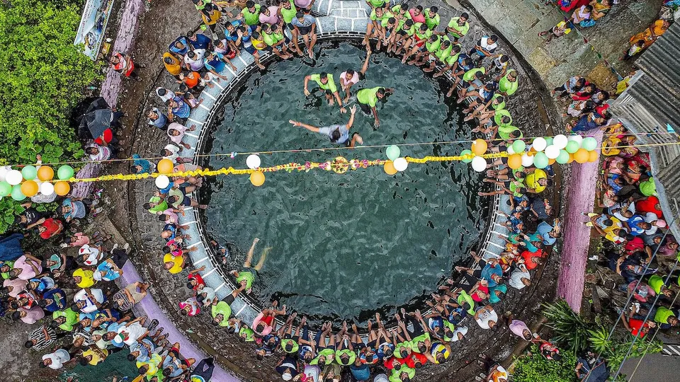 Govindas dive to break the ‘Dahi Handi’ tied above a well at Kurdus on the occasion of Krishna Janmashtami, in Alibaug, Thursday, Sept. 7, 2023