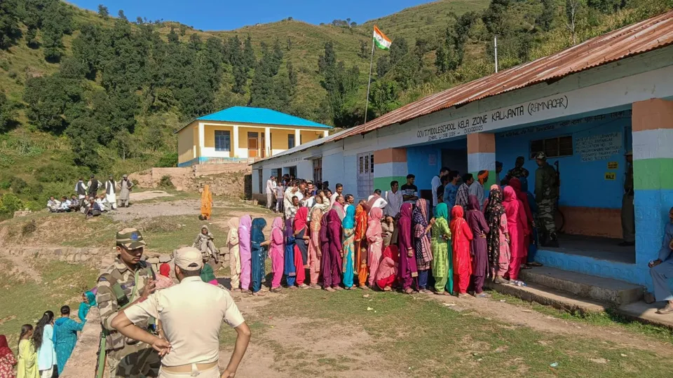 People wait in queues to cast their votes at a polling booth during the third and final phase of Jammu & Kashmir Assembly elections, in Udhampur district, J&K, Tuesday, Oct. 1, 2024.
