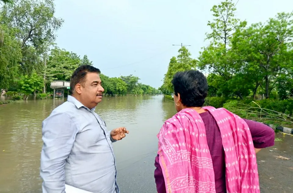 Delhi minister Atishi Singh oversees floodwater clearance work on the Ring Road, in New Delhi, Sunday.jpg