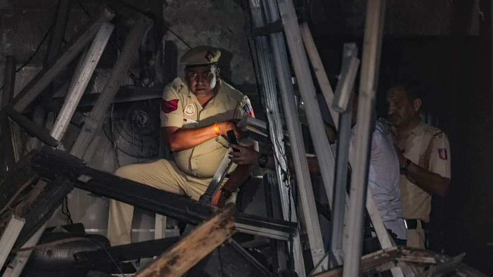 A police personnel collects documents at the Baby Care Hospital after a fire broke out here that killed seven newborns, in east Delhi, Sunday, May 26, 2024. 