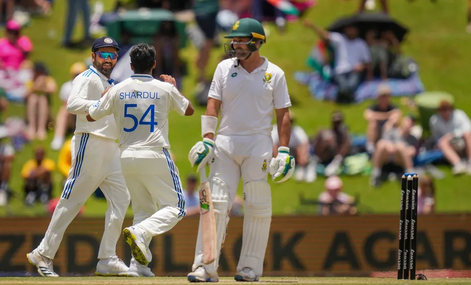 Shardul Thakur with captain Rohit Sharma celebrates the wicket of South African batter Dean Elgar
