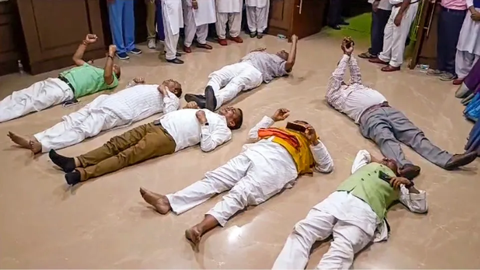 Jharkhand BJP MLAs lie on the floor during their protest inside the Jharkhand Legislative Assembly during the Monsoon session, in Ranchi, Wednesday, July 31, 2024.
