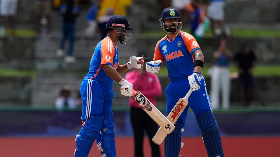 Virat Kohli, right, celebrates scoring runs with batting partner Rishabh Pant during the ICC Men's T20 World Cup cricket match between India and Bangladesh at Sir Vivian Richards Stadium in North Sound, Antigua and Barbuda, Saturday, June 22, 2024.