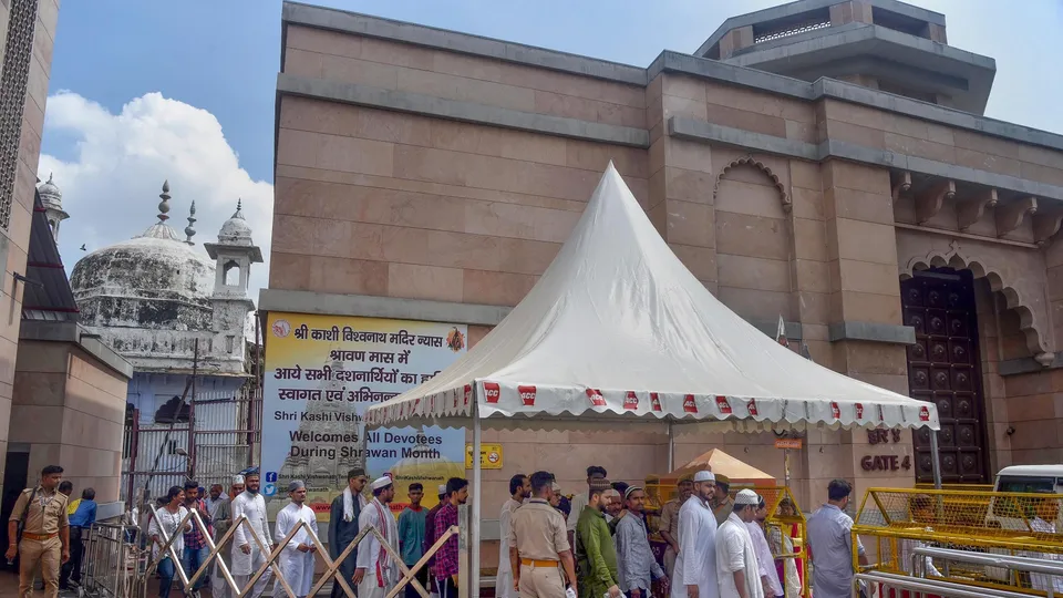 Muslims come out of the Gyanvapi mosque after offering Friday prayers amid tight security, in Varanasi