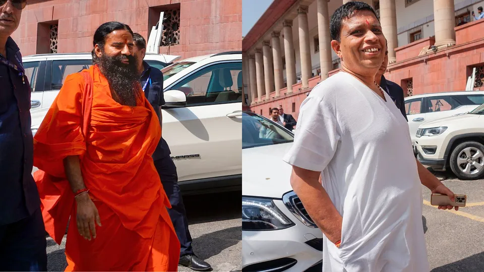 Baba Ramdev (L) and Acharya Balkrishna (R) arrives at the Supreme Court for a hearing on the Patanjali misleading advertisements case, in New Delhi, Tuesday, April 23, 2024