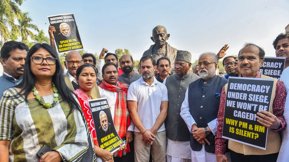 Congress MPs Mallikarjun Kharge and Rahul Gandhi with suspended Opposition MPs during a protest at Mahatma Gandhi statue