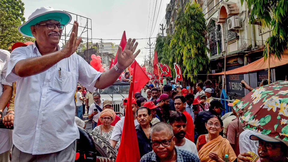 CPI(M) supporters during a road show of party candidate Sujan Chakraborty for Lok Sabha elections, in Kolkata, Sunday, April 28, 2024.