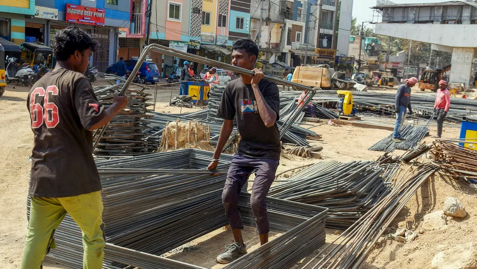 Workers at a construction site, on the day of the presentation of the Interim Budget 2024 by Union Finance Minister Nirmala Sitharaman, in Hyderabad