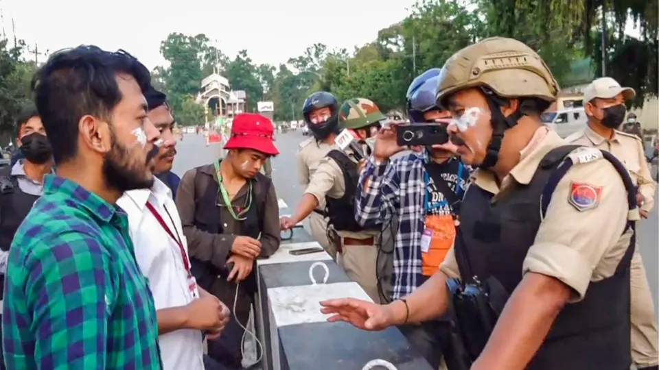 Security personnel talk to students during their protest over recent violence, in Imphal, Tuesday, Sept. 10, 2024.