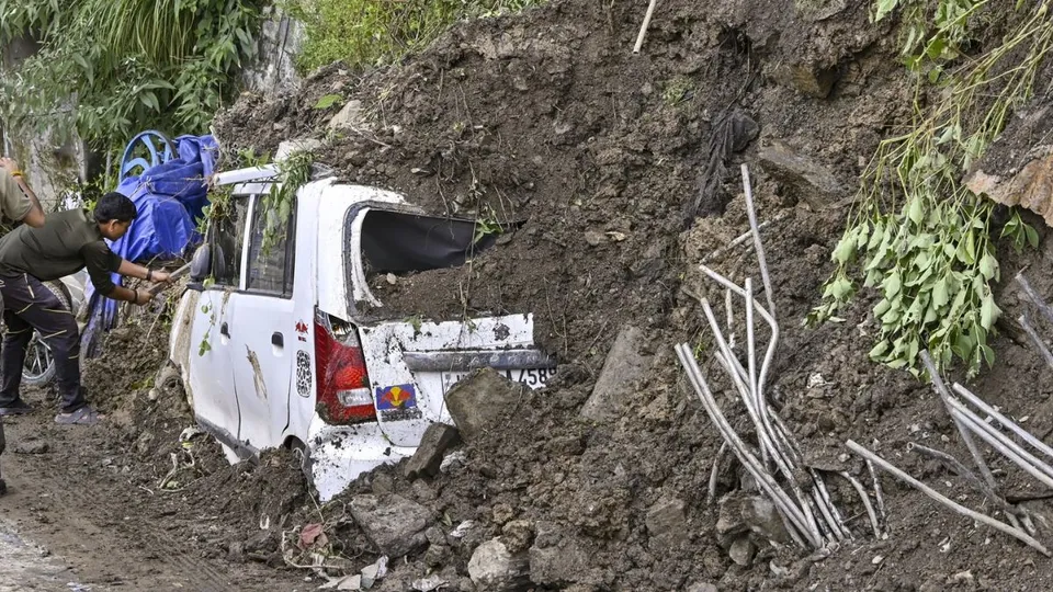 A vehicle buried under the debris after landslide at Sanjauli, in Shimla, on Wednesday