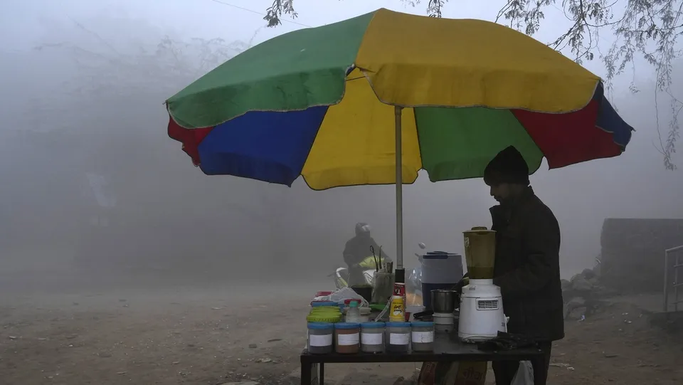 A street vendor amid fog on a cold winter morning, in New Delhi, Sunday