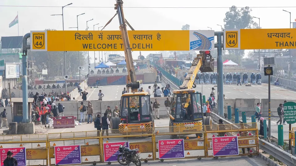 Police remove 'Welcome to Delhi' signboard as security arrangements have been tightened near the Singhu border