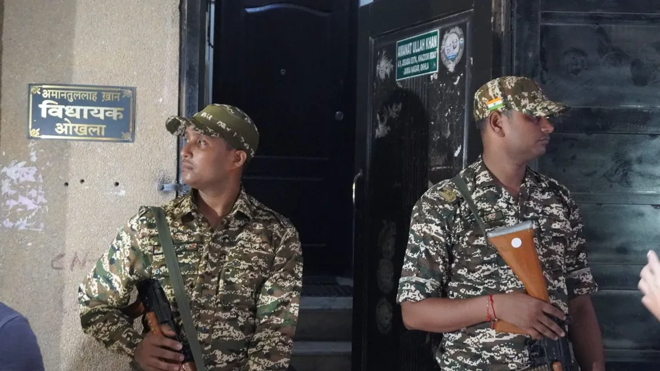 Security personnel stand guard at the residence of Aam Aadmi Party (AAP) MLA Amanatullah Khan during raids by the Enforcement Directorate, in New Delhi, Monday, Sept. 2, 2024.