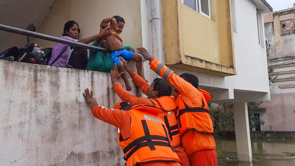 NDRF personnel evacuate residents from a waterlogged area after heavy rainfall owing to Cyclone Michaung, in Kanchipuram