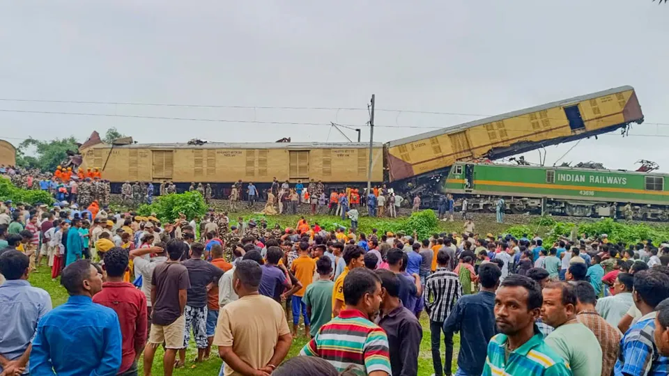 Locals gather after a collision between the Kanchanjungha Express and a goods train, near Rangapani railway station, on Monday, June 17, 2024.
