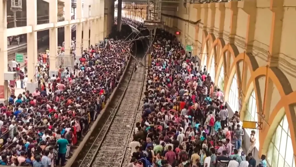 Passengers board a train at the Velachery railway station, during the IAF air show at the Marina Beach, Sunday, Oct. 6, 2024.