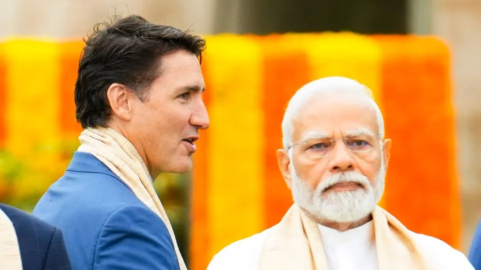 Canada's Prime Minister Justin Trudeau, left, walks past India's Prime Minister Narendra Modi as they take part in a wreath-laying ceremony at Raj Ghat during the G20 Summit in New Delhi