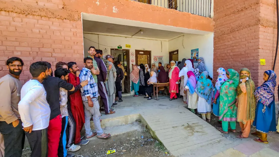Voters wait in a queue at a polling station to cast their votes for the fifth phase of Lok Sabha elections, in Baramulla, Monday, May 20, 2024