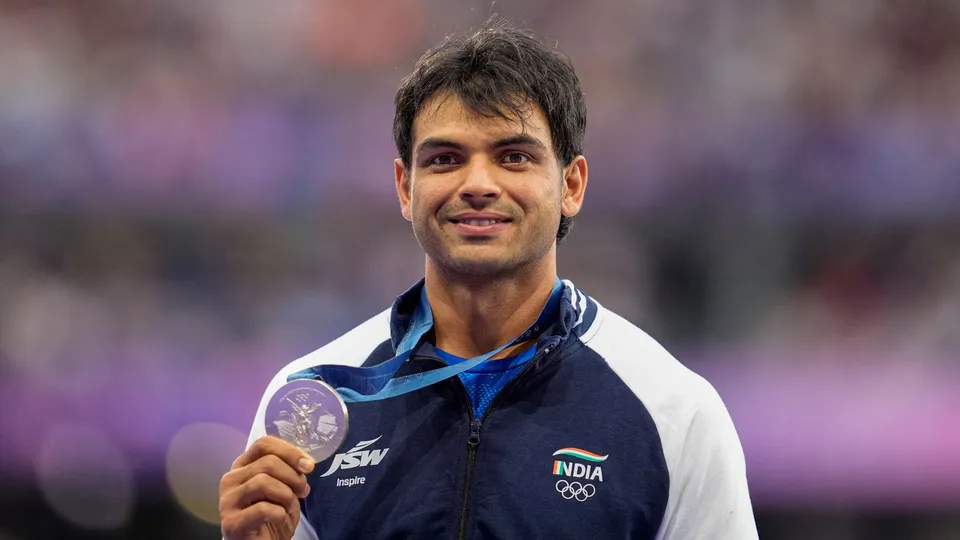 Silver medalist India's Neeraj Chopra poses for photos at the podium during the victory ceremony for the men's javelin throw final event at the 2024 Summer Olympics, in Paris, France, Friday, Aug. 9, 2024.