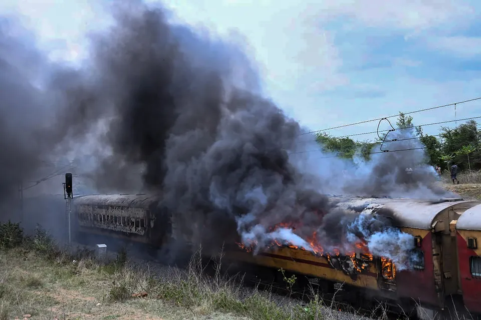 Smoke billows from the Falaknama Express train after it caught fire, in Yadadri Bhuvanagiri district, Telangana