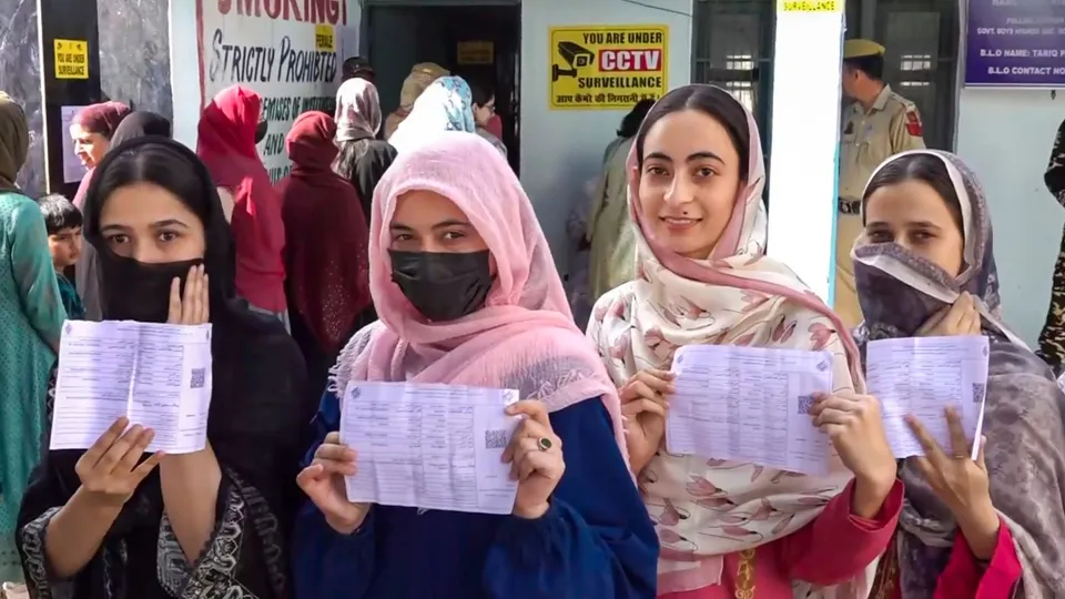 Women voters show their voting slips at a women-only polling station during the first phase of Jammu and Kashmir Assembly elections, in Kishtwar district, Wednesday, Sept. 18, 2024.