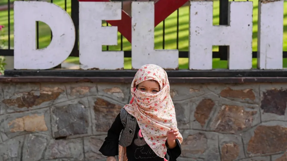 A child visitor wears a scarf on a hot summer day at the National Zoologicial Park, in New Delhi, Tuesday, May 28, 2024. 