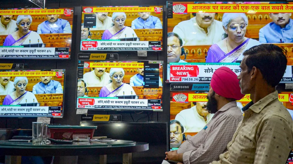 People watch the live telecast of Union Budget 2024-25, being presented by Union Finance Minister Nirmala Sitharaman in the Lok Sabha at a TV showroom, in Amritsar, Tuesday, July 23, 2024.
