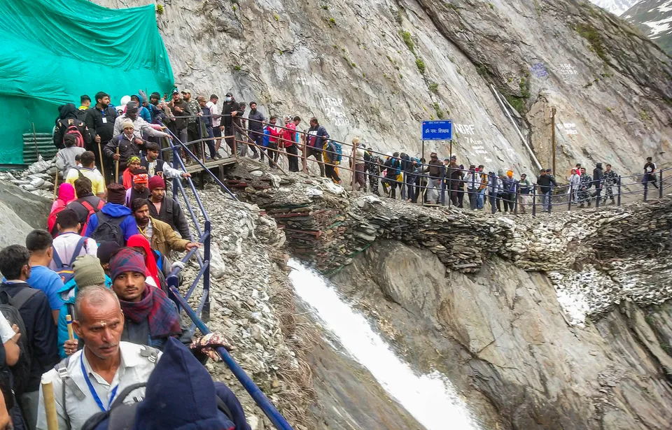 Pilgrims walk towards the holy cave shrine of Amarnath, in Baltal