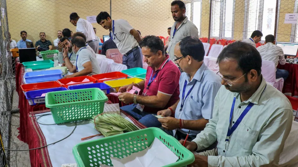 Election officials count votes for the Jammu & Kashmir Assembly elections, at Polytechnic College counting center, in Jammu, Tuesday, Oct. 8, 2024.