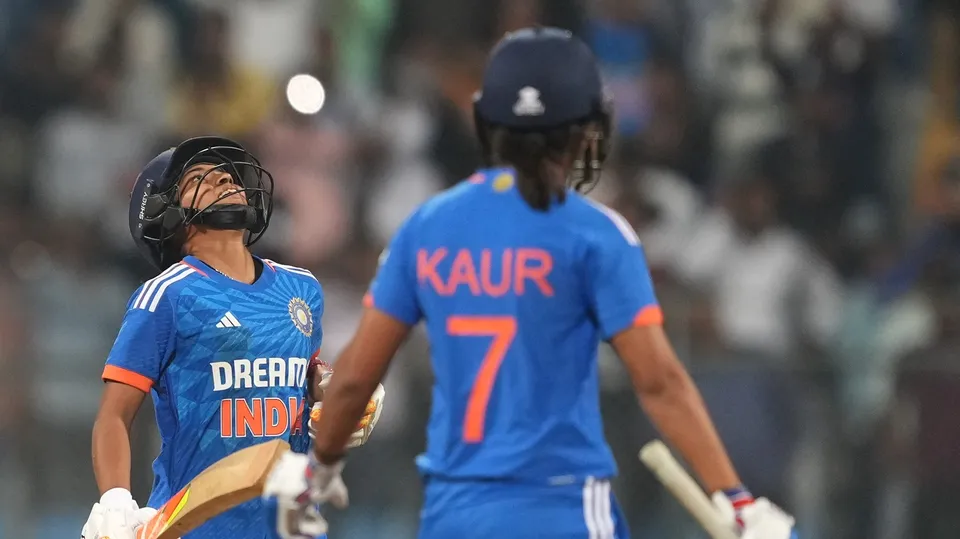 India's Harmanpreet Kaur and Amanjot Kaur celebrate after winning the 3rd T20I cricket match against England