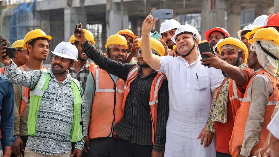 Union Railway Minister Ashwini Vaishnaw takes selfie with workers during an inspection visit of the under-construction Gandhinagar Railway Station, in Jaipur, Tuesday, Sept. 24, 2024.