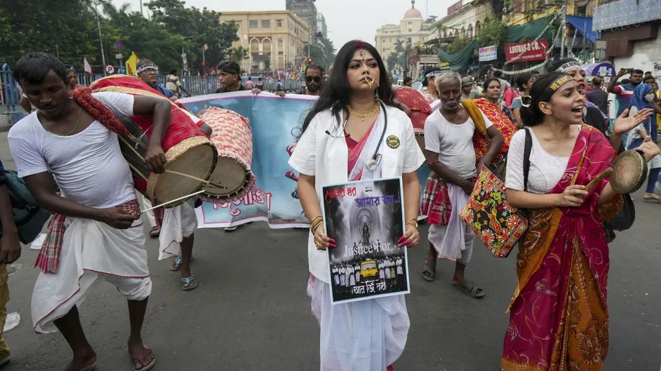An activist holds a poster during a mega rally by members of Bengal Junior Doctors' Front and others on 'Mahalaya' to demand justice for the alleged sexual assault and murder of a trainee doctor at RG Kar Medical College and Hospital, in Kolkata, Wednesday, Oct 2, 2024