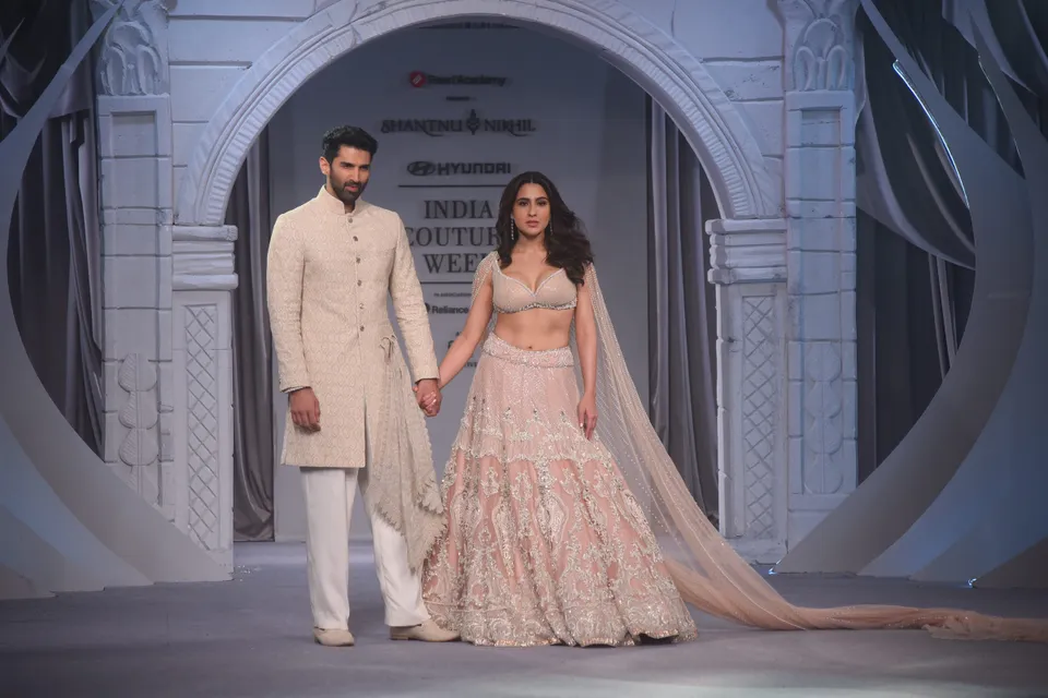 Bollywood actors Sara Ali Khan and Aditya Roy Kapur walk the ramp for designer Shantanu and Nikhil during the India Couture Week, in New Delhi