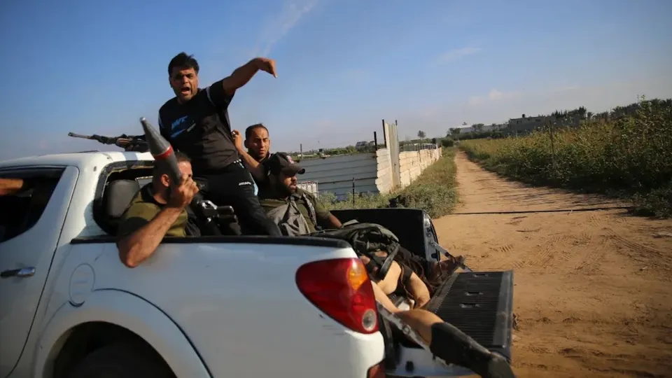 Hamas terrorists with dead body of an Israeli girl